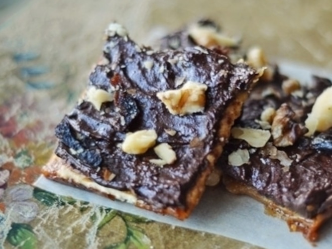 Chocolate walnut dessert squares on table.