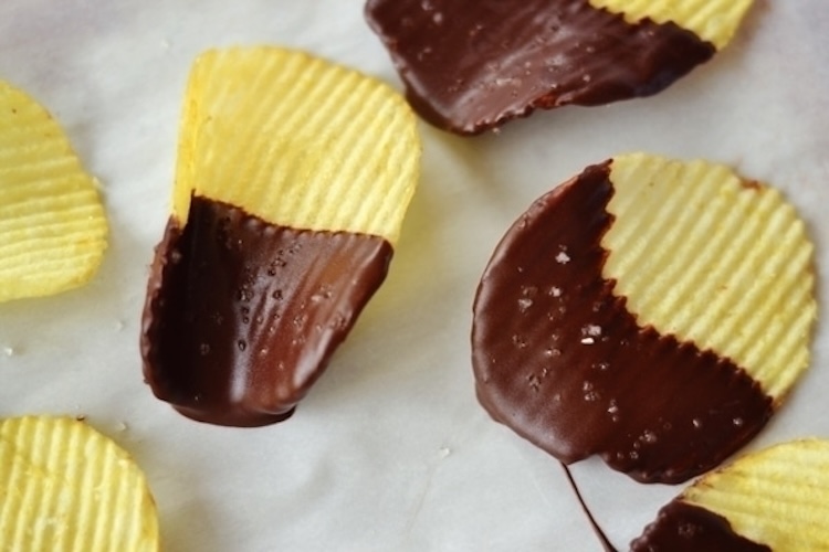 Chocolate-covered potato chips on parchment paper.