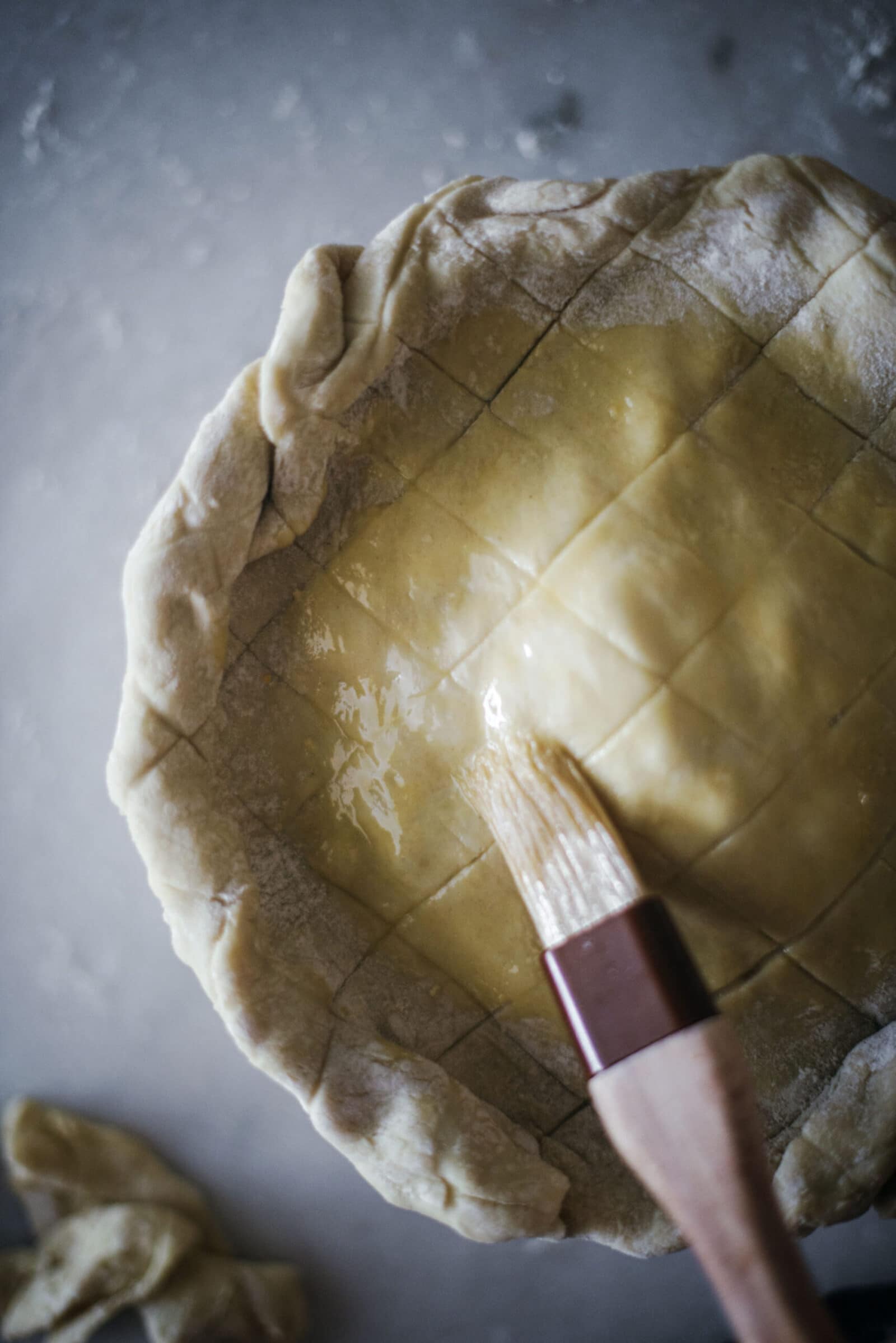 Brushing egg wash on puff pastry