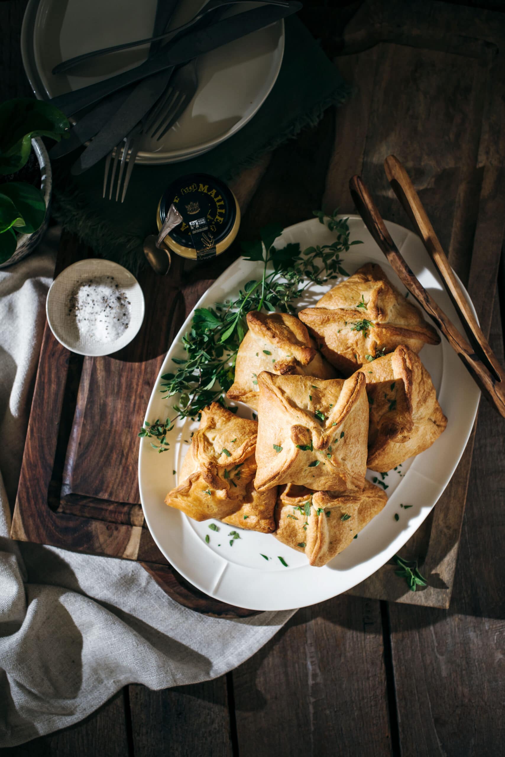 Chicken hand pies on a platter with parsley garnish