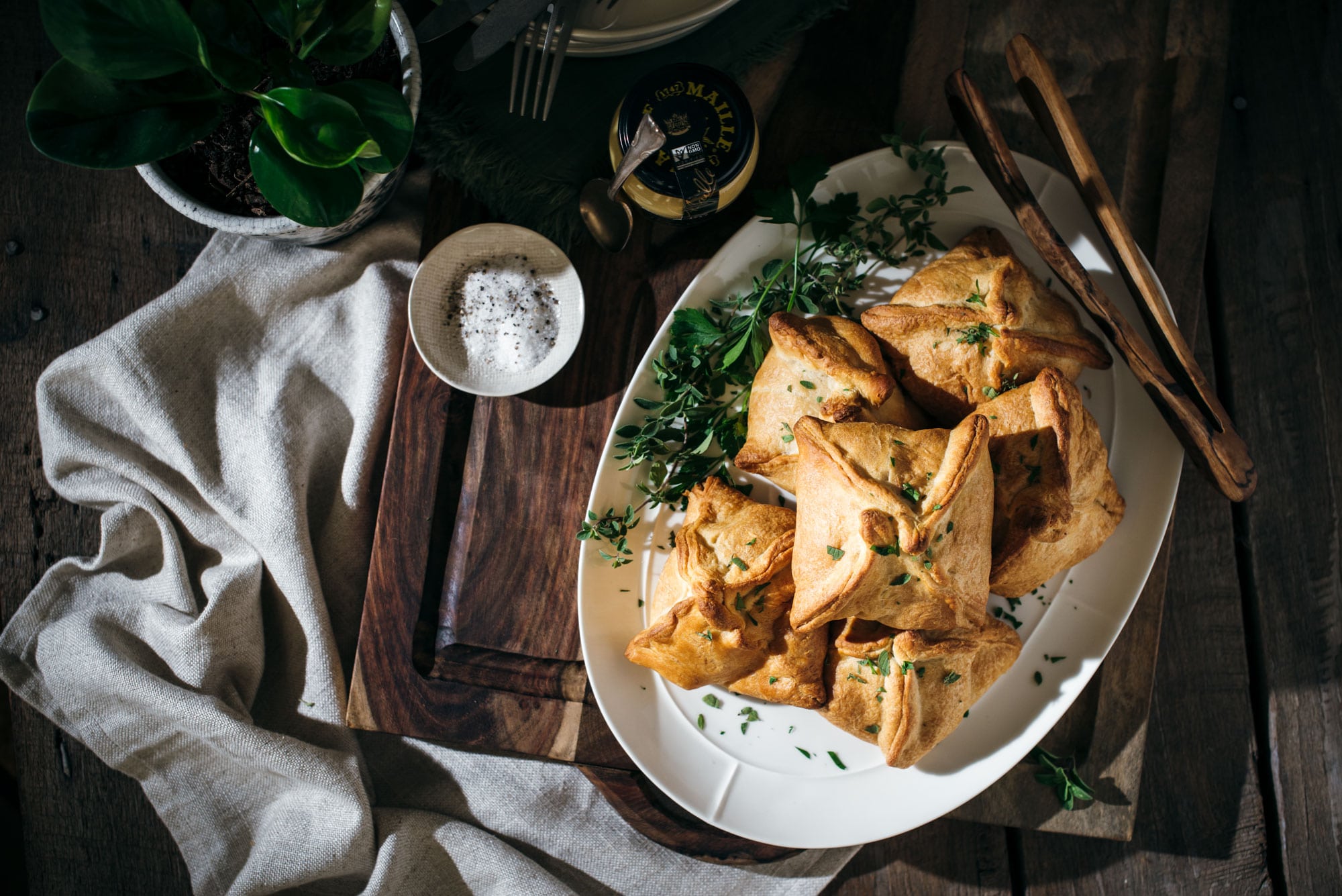 Savory chicken hand pies on a white plate ready to serve