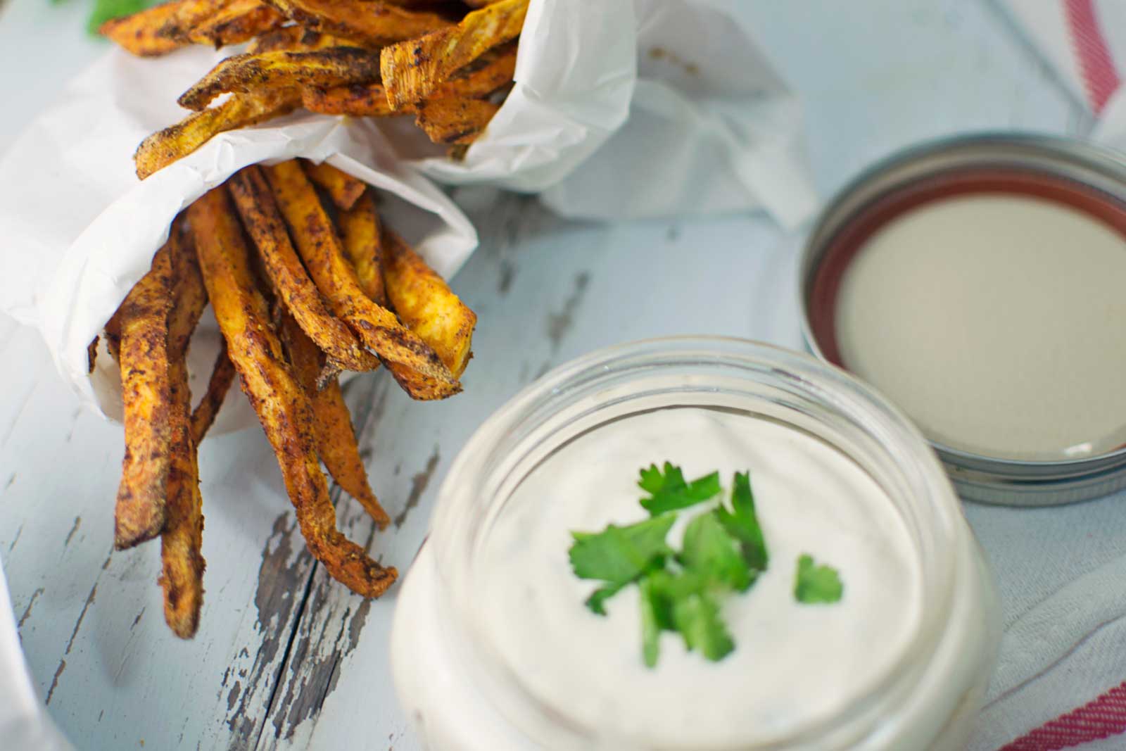 crispy sweet potato fries on a plate with dipping sauce