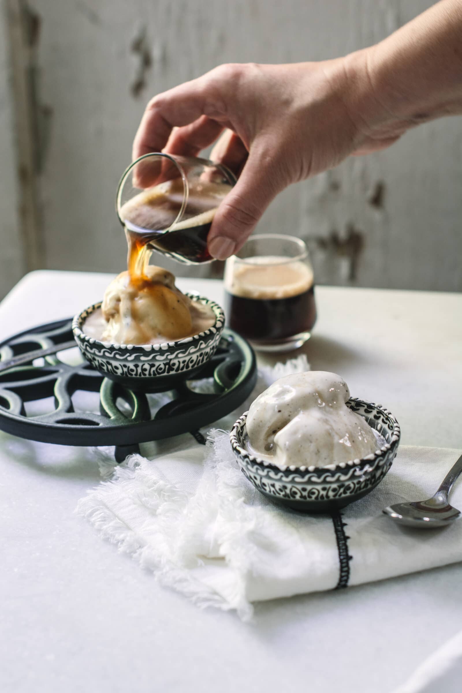 Pouring espresso over vanilla ice cream