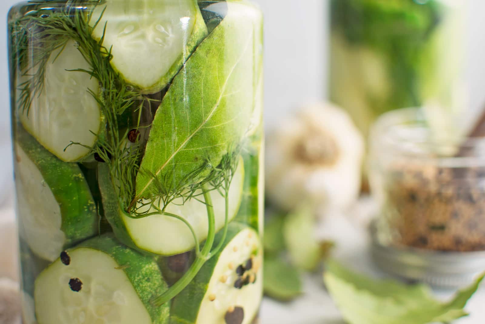 Cucumbers preserved with bay leaves, dill, garlic, and pickling spice.