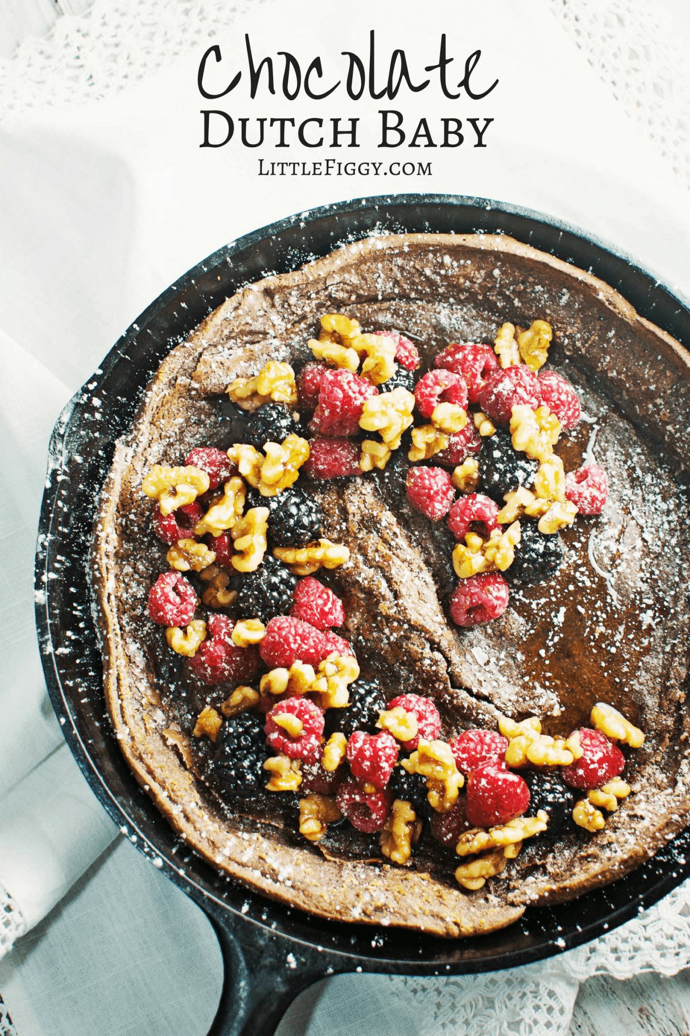 Enjoy a decadent breakfast or dessert with this Chocolate Dutch Baby served with fresh fruit and drizzles of warmed maple syrup and toasted walnuts! Get the recipe at LittleFiggyFood