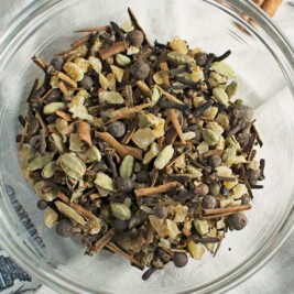 Glass bowl with mixed spices and herbs.