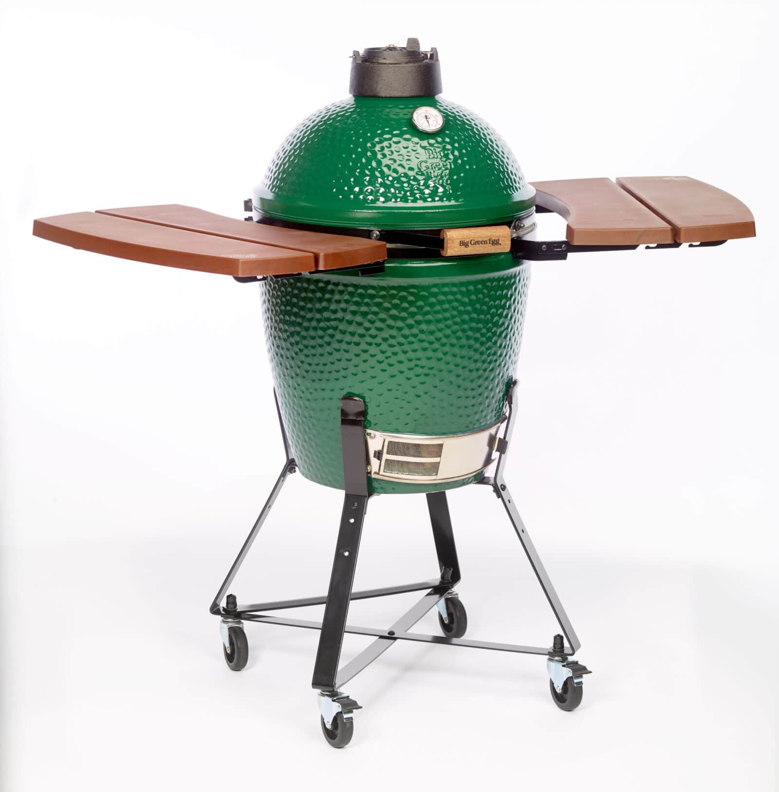 A green ceramic grill with a dome-shaped lid, built-in thermometer, wooden side shelves, and a black metal stand with wheels—perfect for grilling lamb to juicy perfection.