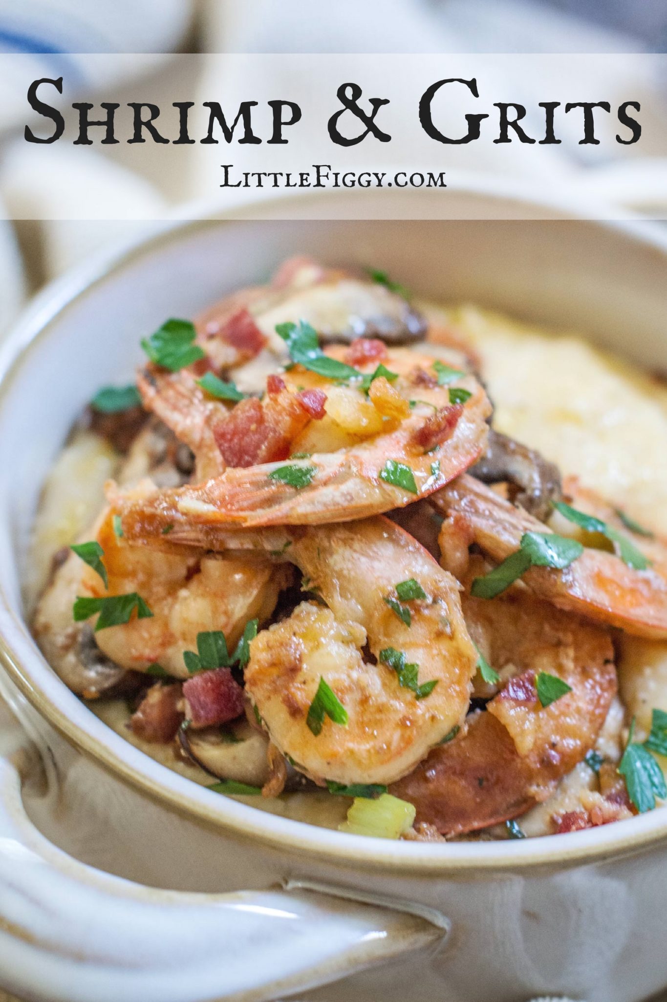 A bowl of Shrimp and Grits topped with sautéed shrimp, diced bacon, mushrooms, and chopped parsley, with the text Shrimp & Grits LittleFiggy.com at the top.
