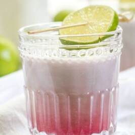 Coconut passion fruit latte with lime garnish.
