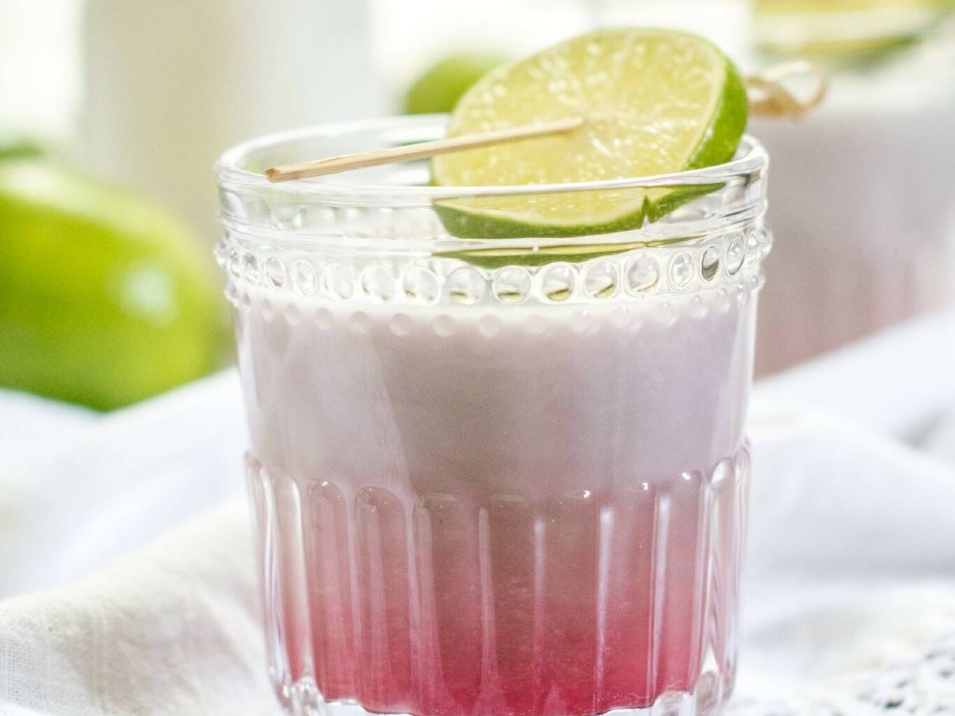 Coconut passion fruit latte with lime garnish.