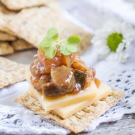Cheese and chutney on crackers with flowers