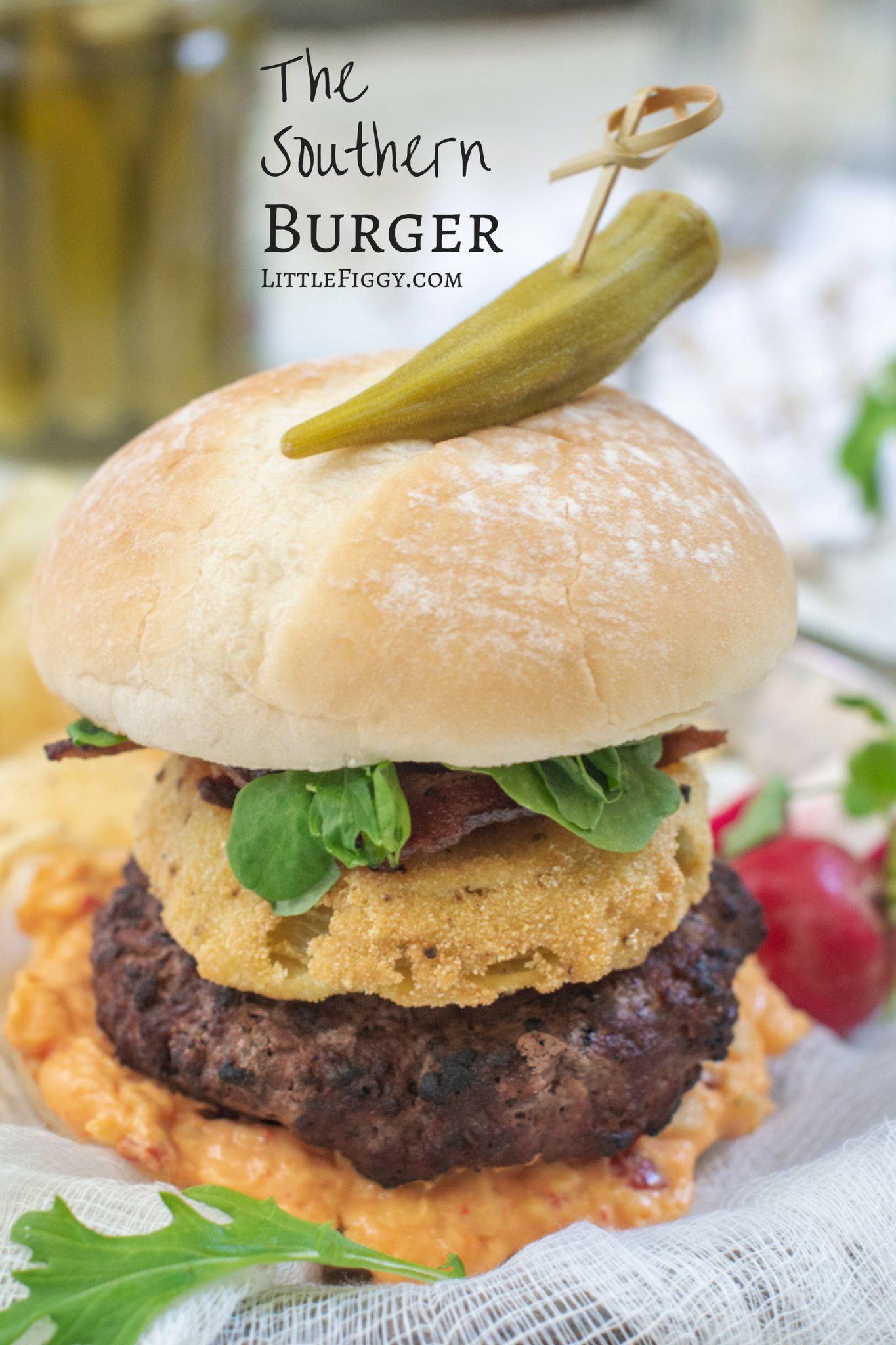 Soft bun with the southern burger topped with fried green tomatoes and bacon.