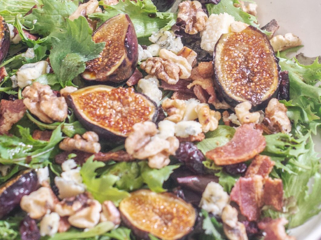 Grilled fig salad with walnuts and greens.