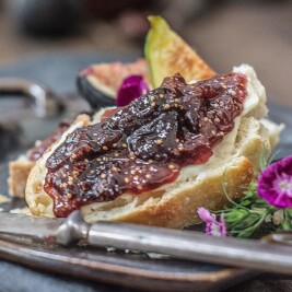 Bread with fig jam and fresh figs on plate