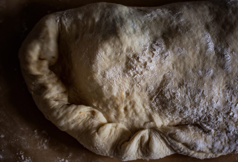 Fold and crimp the edges of the calzone recipe