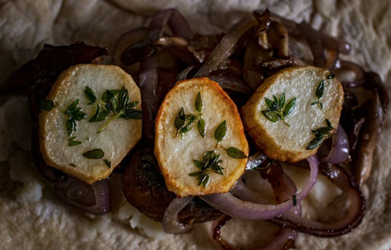 Layer the ingredients, mashed potatoes, sautéed onions and mushrooms, crispy potatoes.