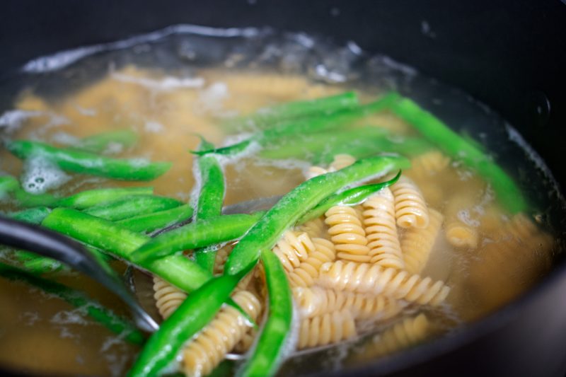 Cooking the easy gluten free pasta with green beans for the almond pesto dish