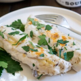 Creamy mushroom enchiladas with parsley garnish
