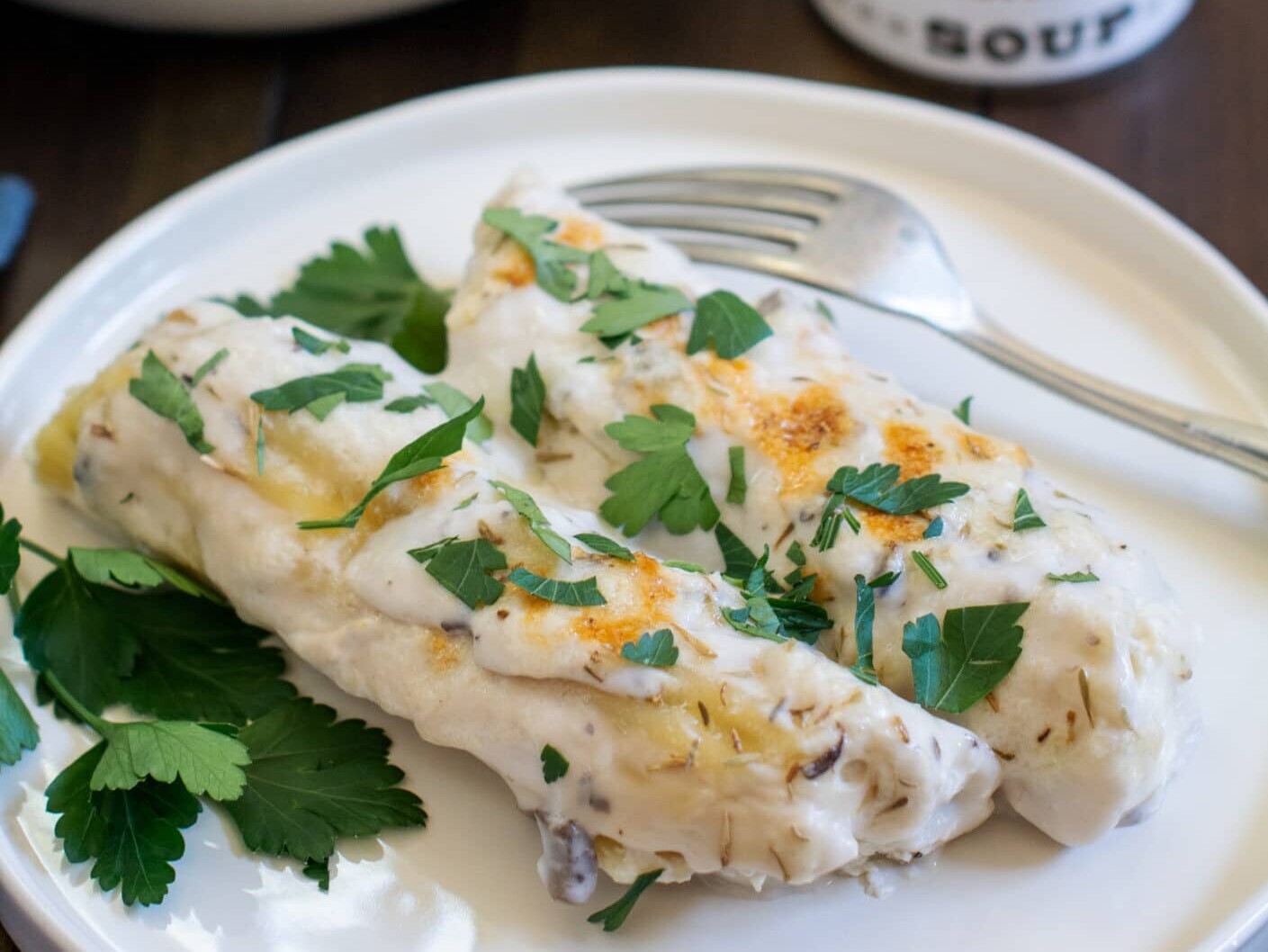 Creamy mushroom enchiladas with parsley garnish