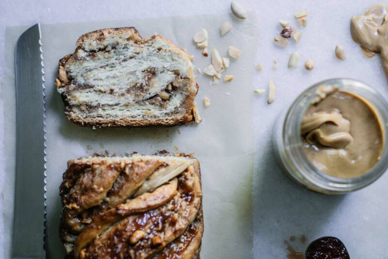 Looking at bread overhead with jar of peanut butter