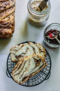 Enjoying slices of Peanut Butter and Jelly Babka with extra peanut butter and jam on the side