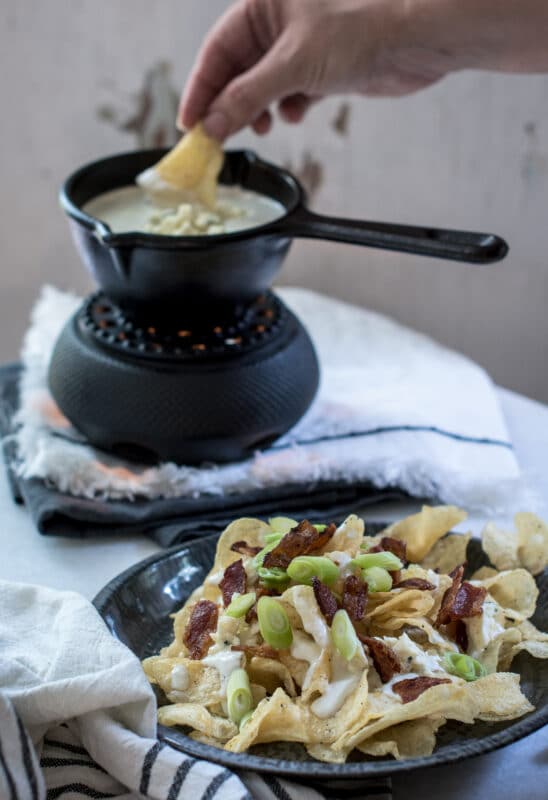 Dipping kettle chips in the blue cheese dipping sauce.
