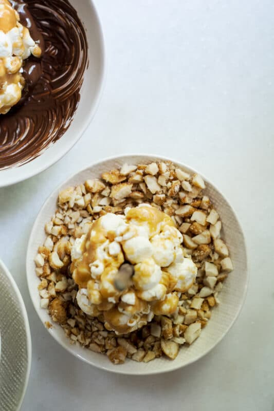 Dipping the lollipop treats in peanuts