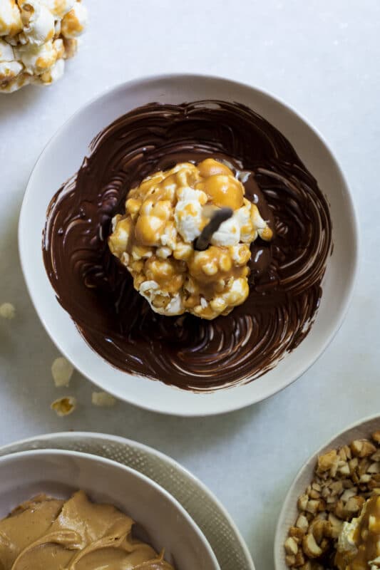 Dipping the popcorn lollipops in chocolate