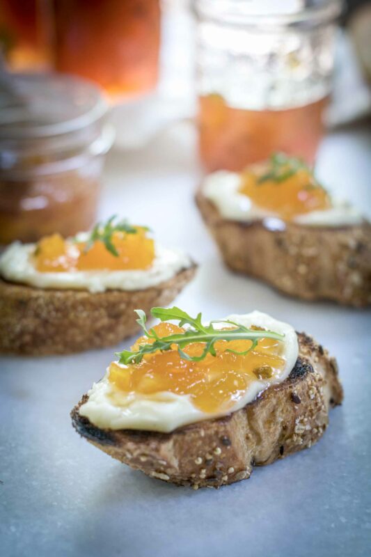 Bruschetta appetizers with brie and pepper peach jam