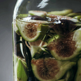 Fresh figs soaking in a glass jar