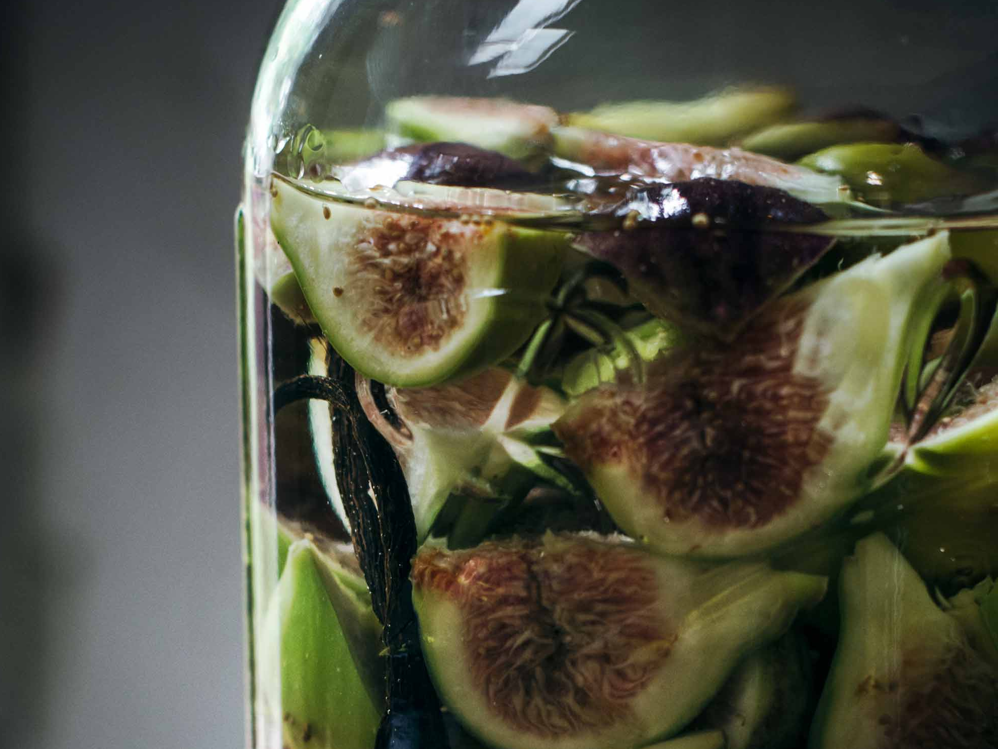Fresh figs soaking in a glass jar