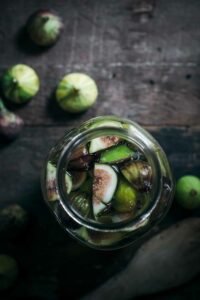 bottle of homemade fig infused vodka with fresh figs