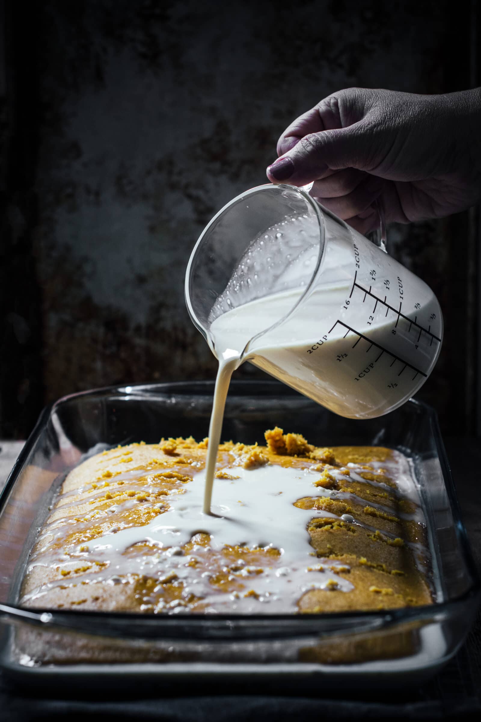 Pouring the three milks over the pumpkin sponge cake