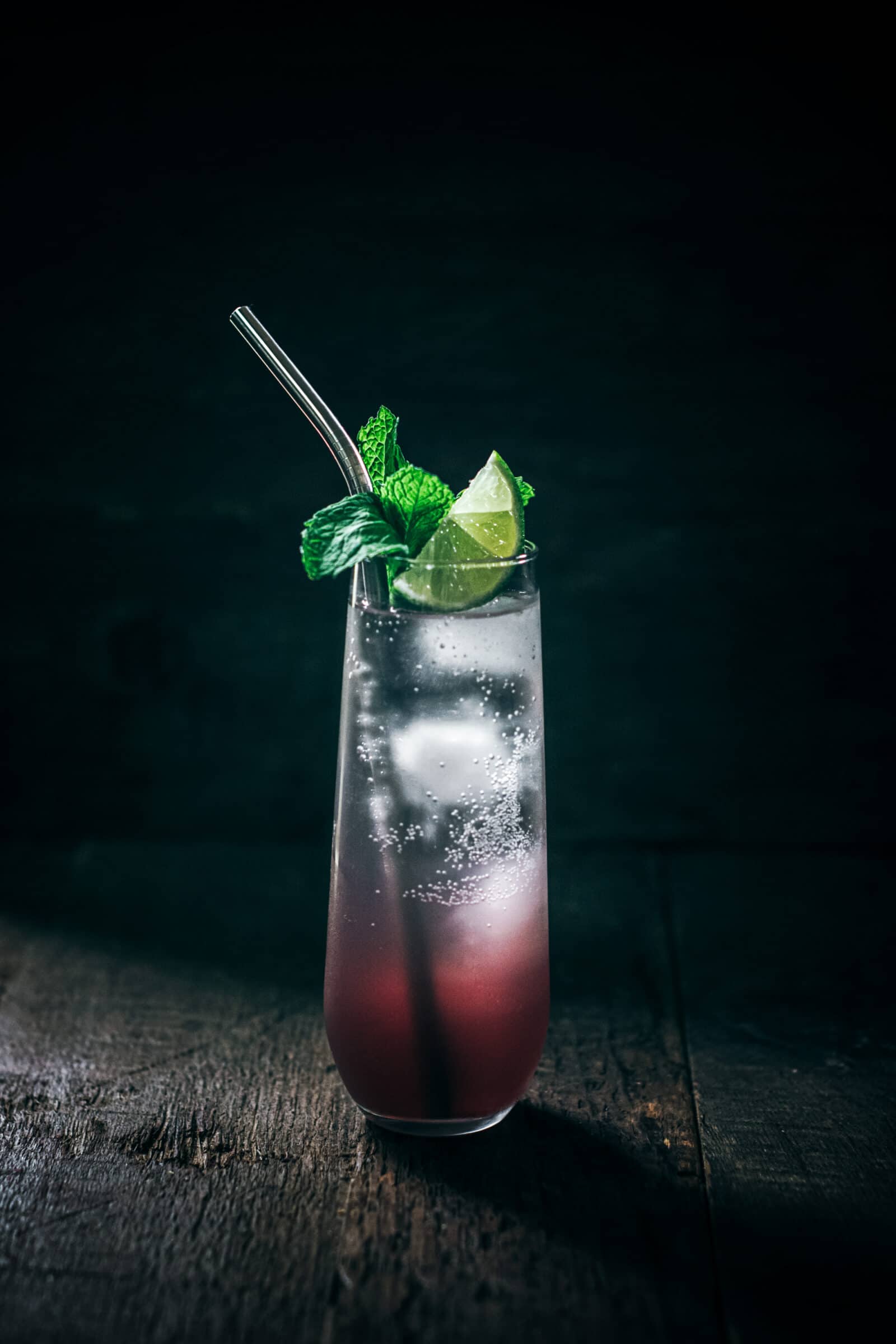 A winter sangria mojito cocktail garnished with mint