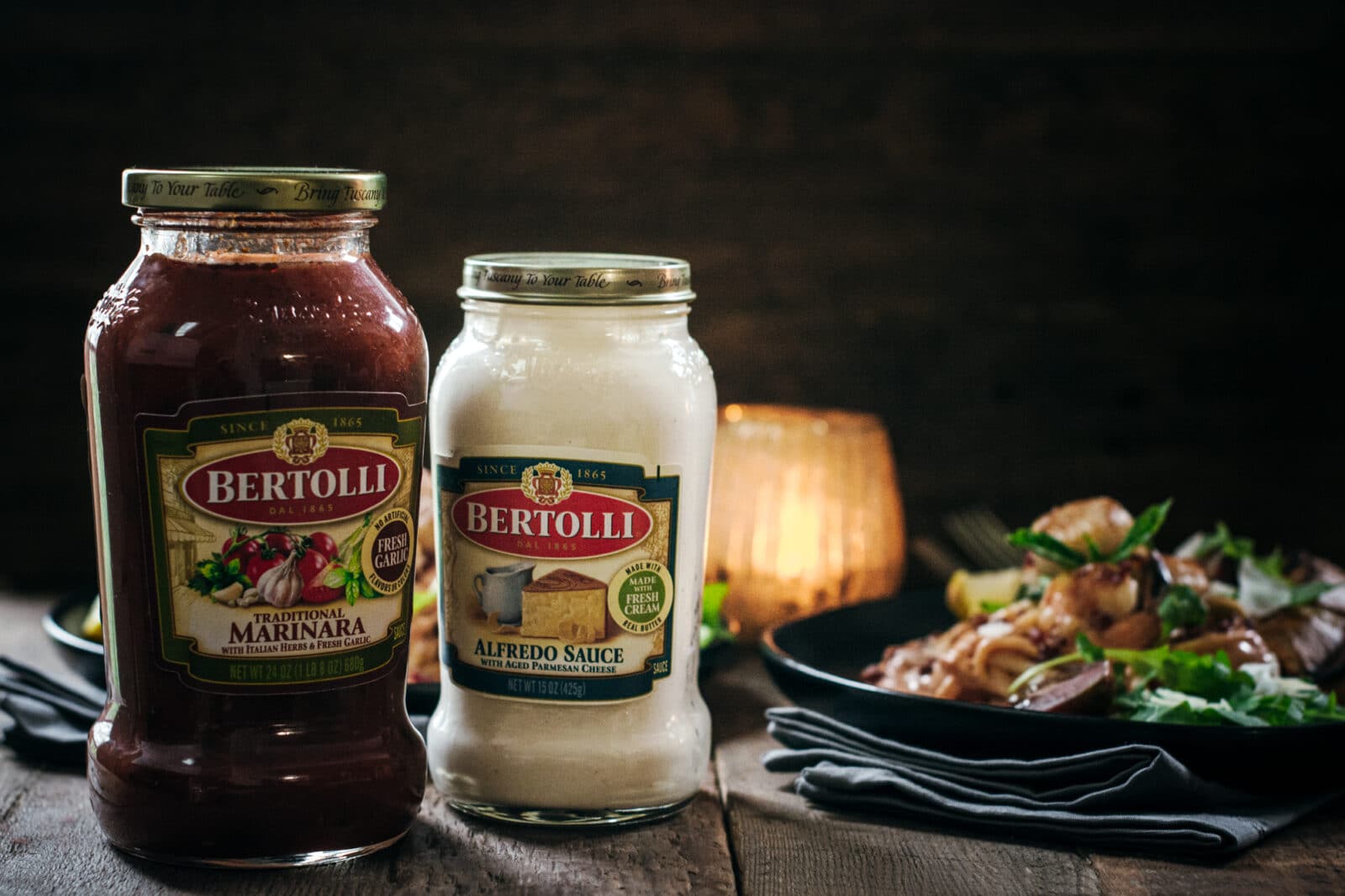 Bertolli Sauces next to shrimp and scallops with pasta
