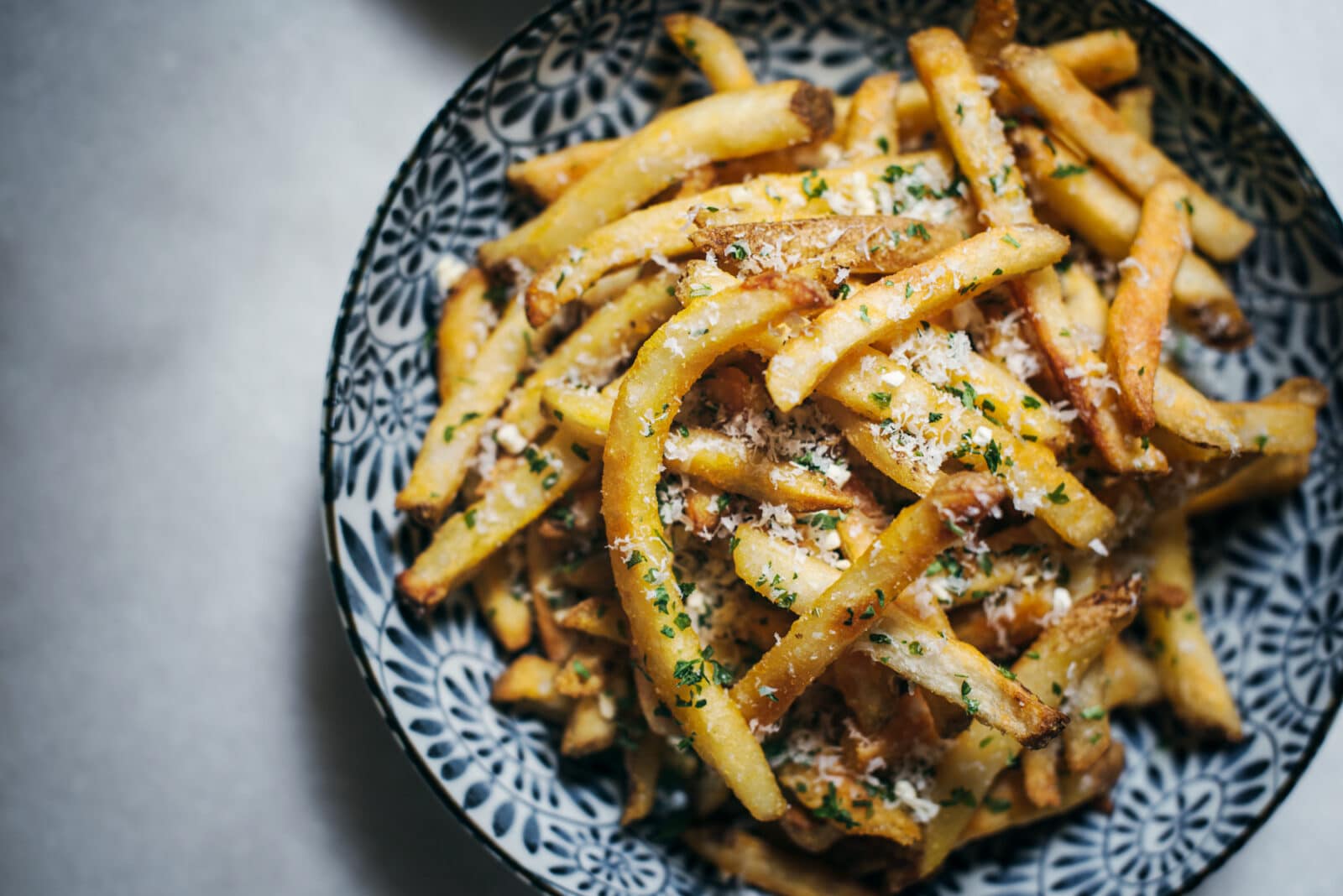 Bowl of golden seasoned oven french fries