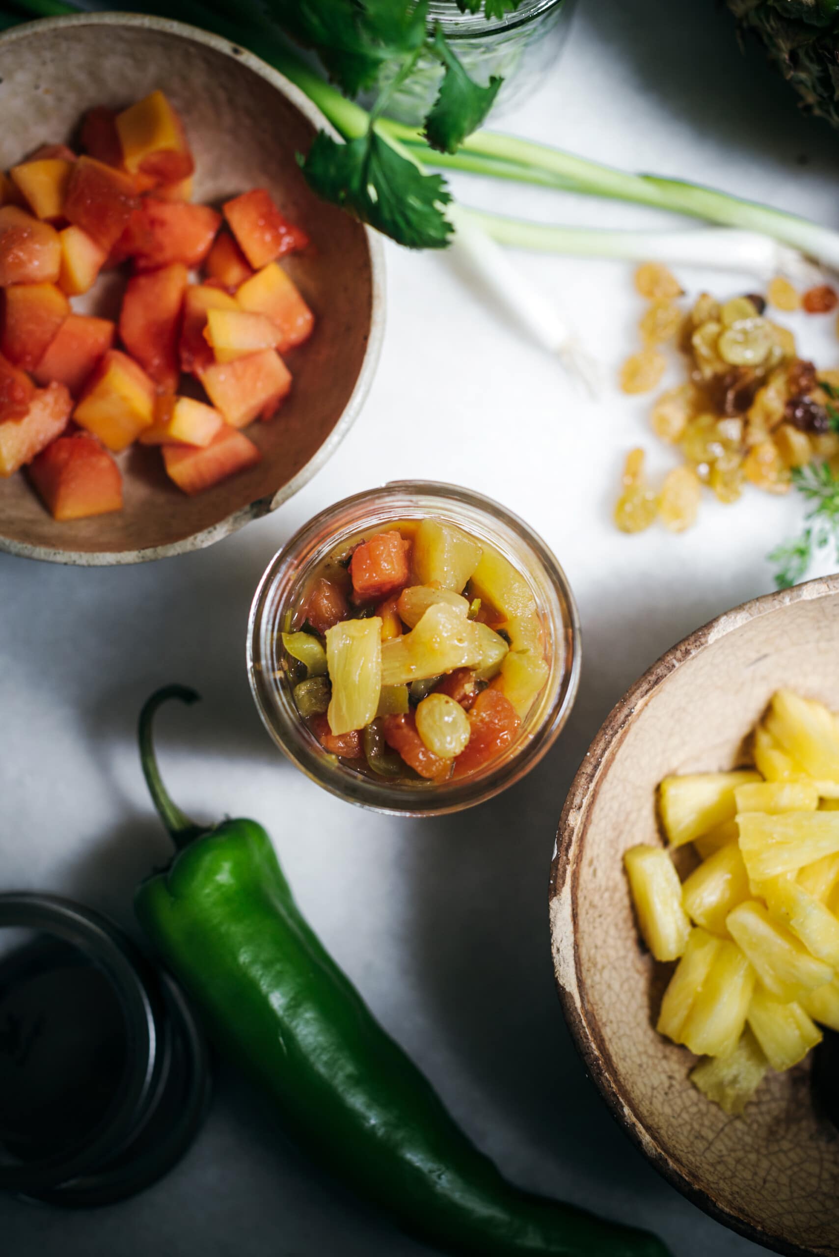 Jar of pineapple salsa and ingredients