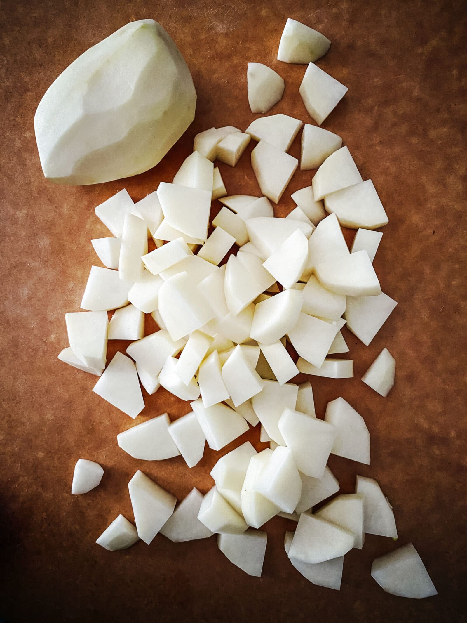 chopped potatoes on chopping board