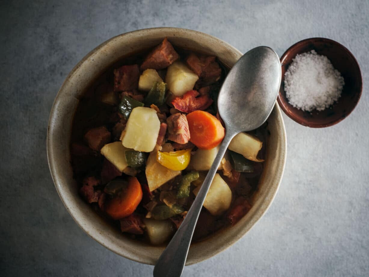 Hearty vegetable stew served with salt.
