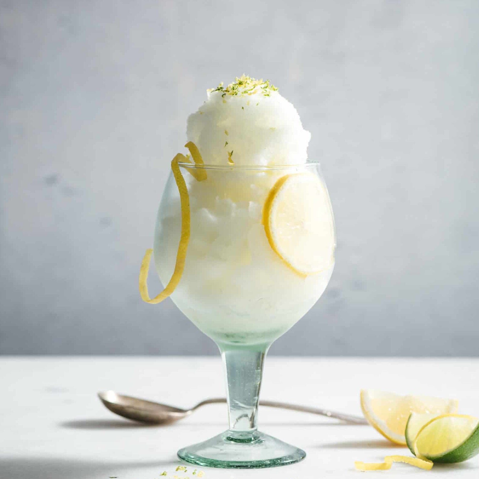 Lemon sorbet in glass with zest garnish