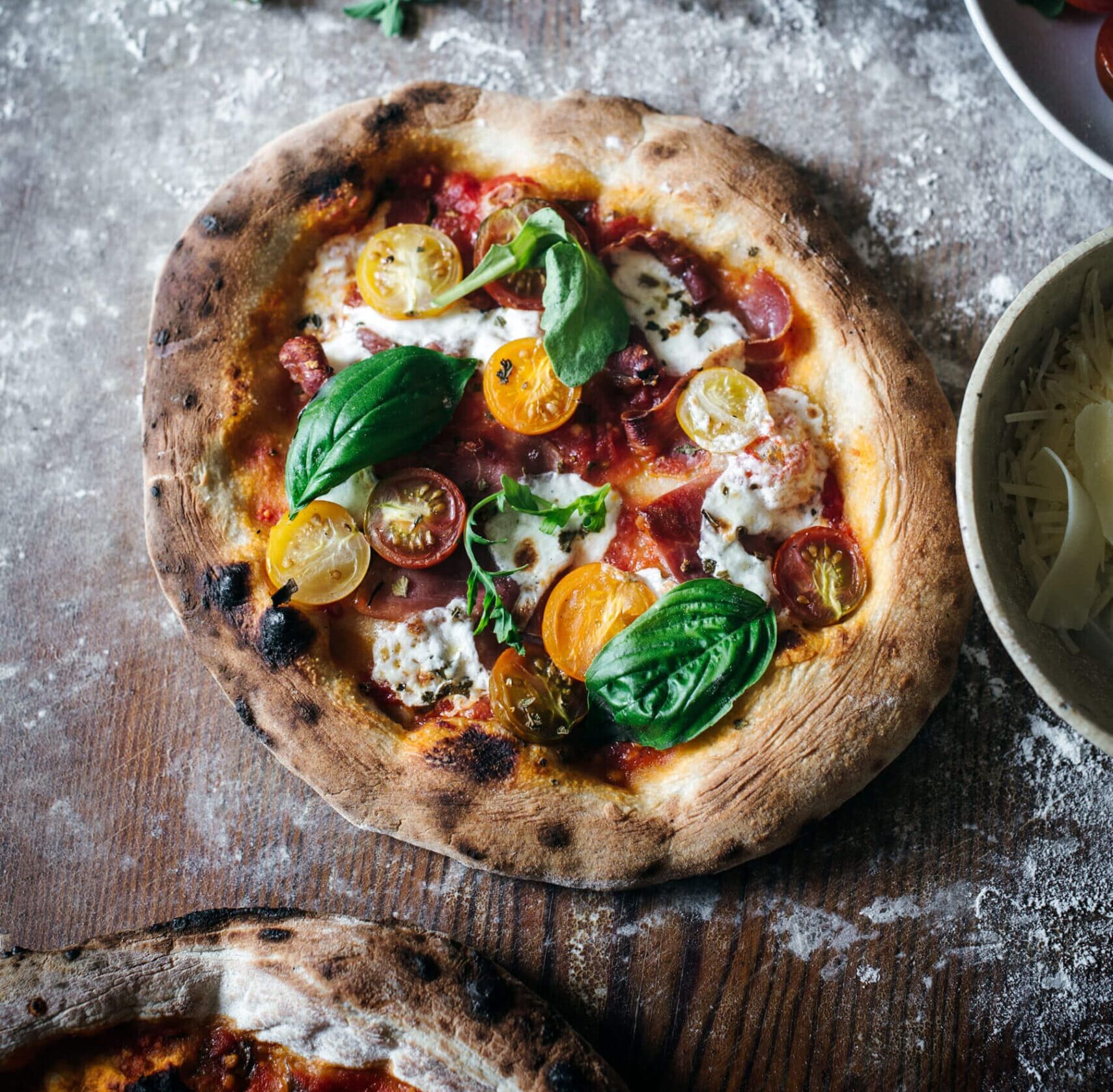 Calabrian pepper and prosciutto pizza ready to slice and serve