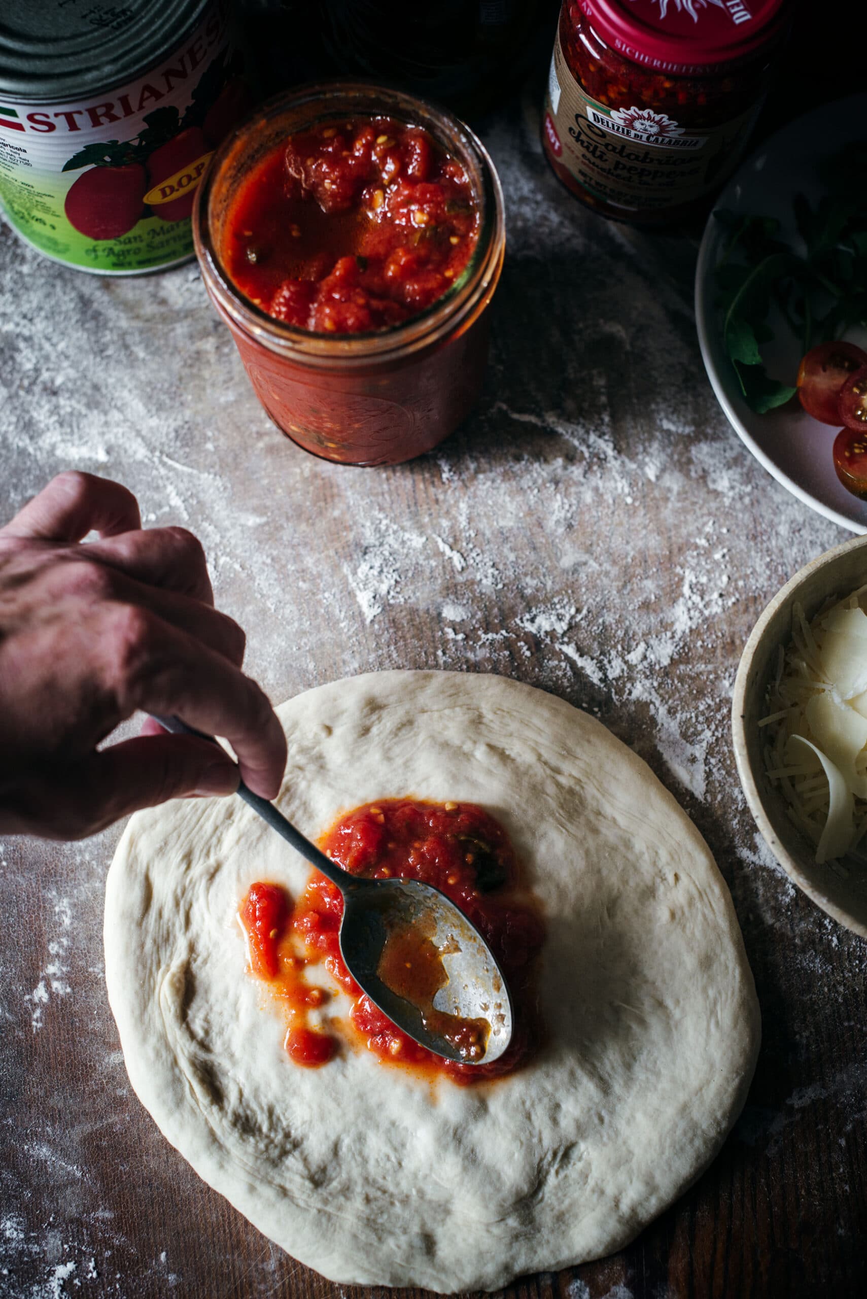 Saucing the pizza base