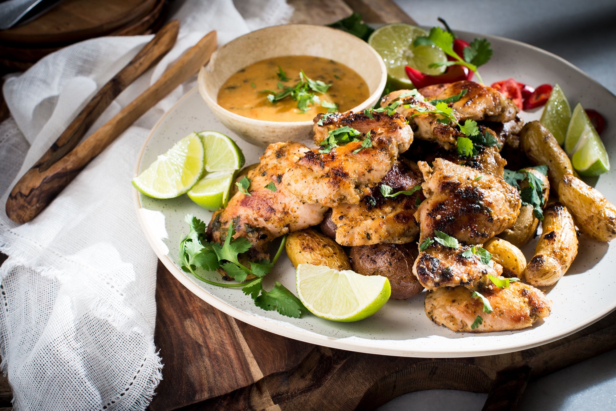 Board with large platter of chicken and potatoes