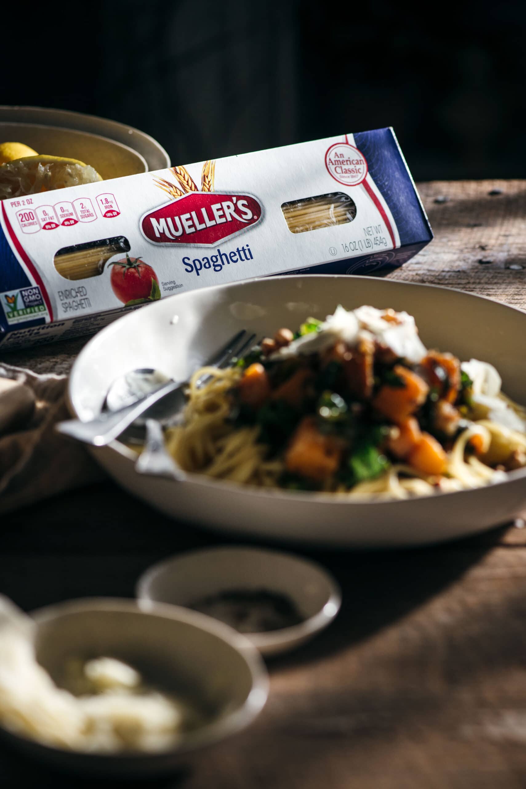 Box of Muellers with bowl filled with pasta inforefront