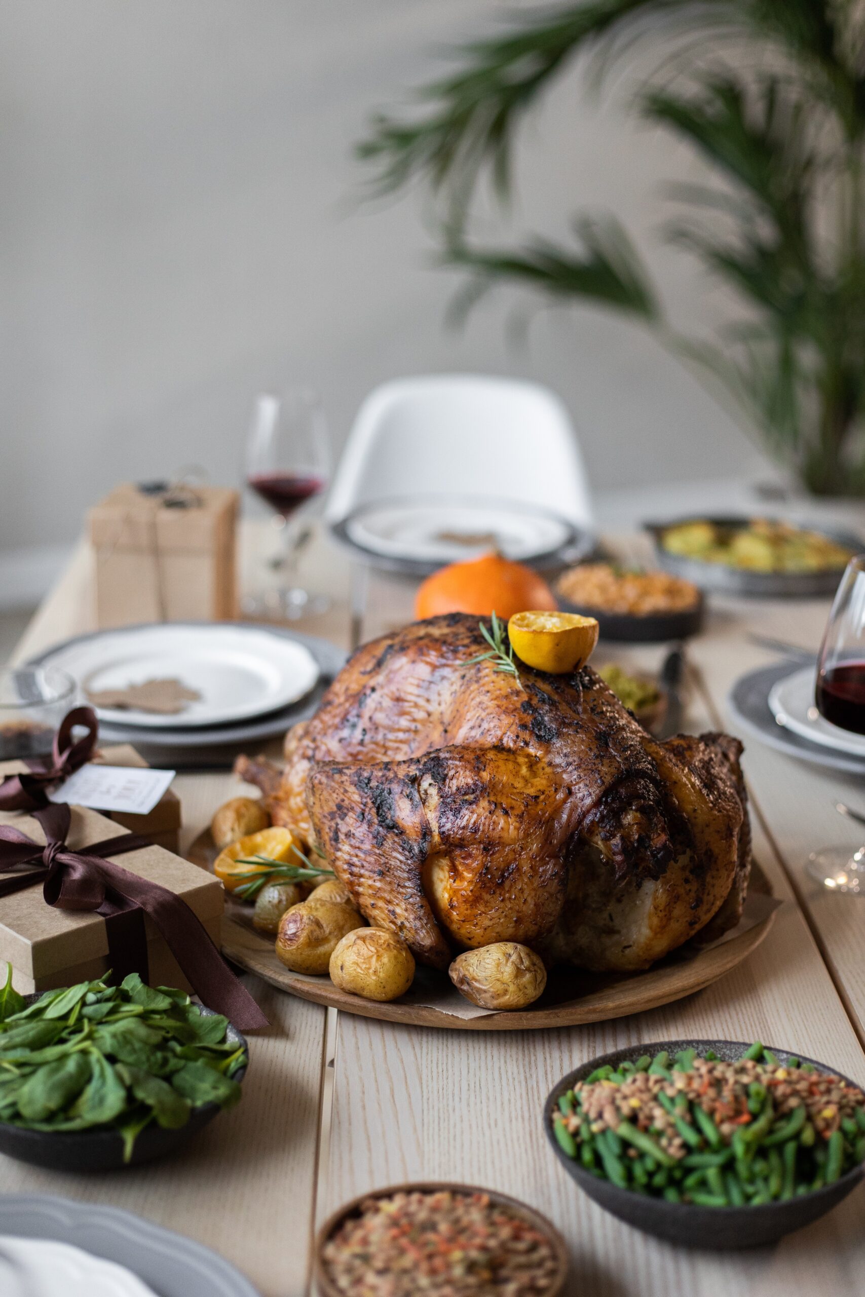 Holiday dinner table with roast turkey and place settings