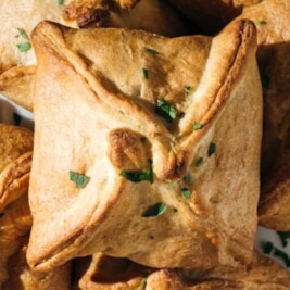 Baked pastries with herbs on wooden table