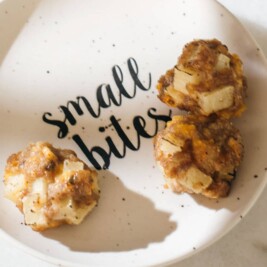 Small bites plate with savory snacks on marble surface.