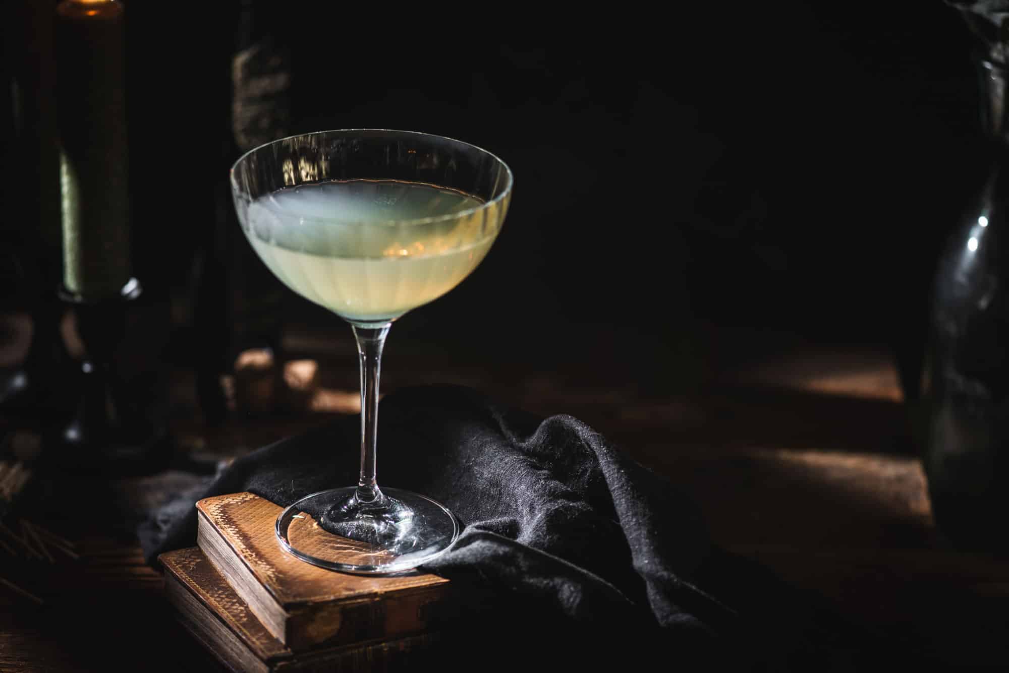 Absinthe Champagne drink in glass on dark table