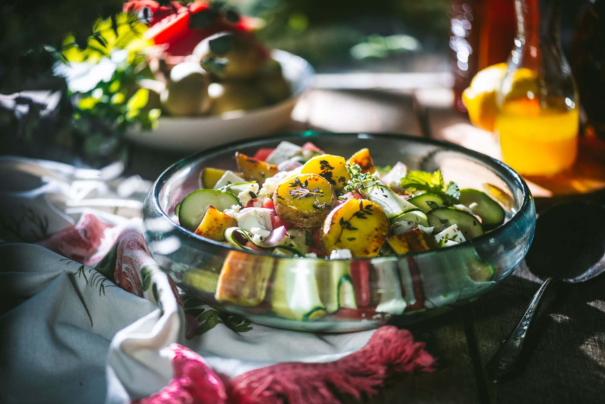 bowl of salad on table with ingredients in background