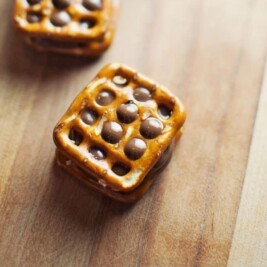 Chocolate pretzels stacked on wooden surface